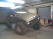 1984 Ford Bronco II - This heavily modified SUV is parked indoors with a large roll-up door in the background.
