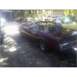 1973 Mercury Cougar - A maroon convertible is parked in a driveway with another car visible in the background.