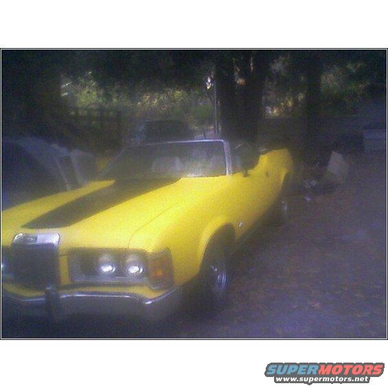 Yellow 1973 Mercury Cougar convertible with black racing stripes