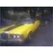 1973 Mercury Cougar - A yellow 1973 Mercury Cougar convertible is parked outdoors, black racing stripes on the hood.