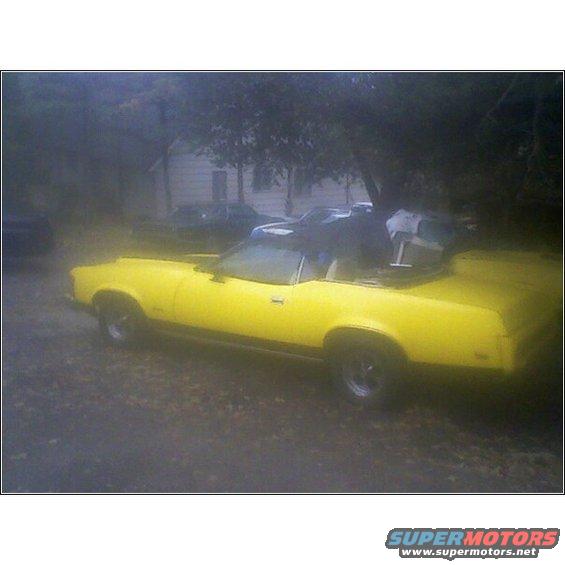 Yellow 1973 Mercury Cougar convertible parked outdoors