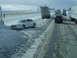 1995 Mercury Grand Marquis - Multiple vehicles, including a white sedan, are on a snow-covered highway during winter conditions.