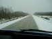1995 Mercury Grand Marquis - Driving through a winter landscape with snow lining the road and trees.