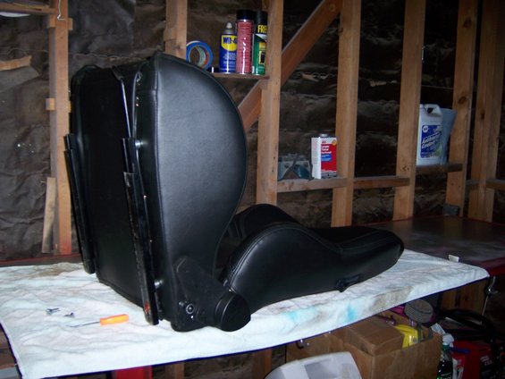 black car seat on a table with tools nearby