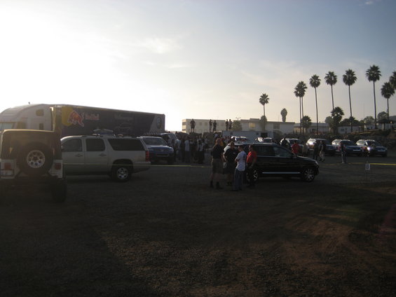 Truck with Red Bull livery and several parked vehicles