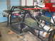1992 Ford Mustang - This custom buggy project is in a garage, a roll cage, racing seats, and storage boxes.