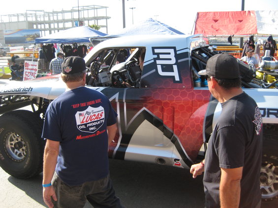 Off-road race truck with number 34 on door, viewed from 3/4 front