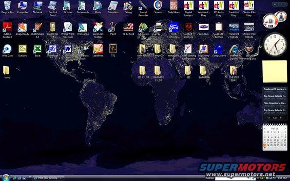 Desktop background of a world map at night with various application icons and a clock