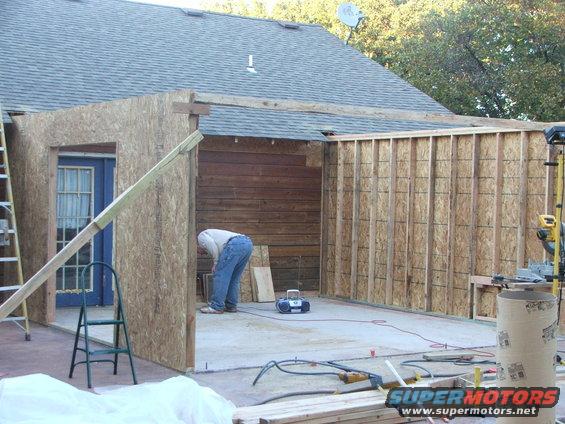 Construction of a room addition with exposed framing and plywood walls