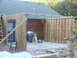 2005 Ford Mustang - A person works on framing a new room addition attached to a house.