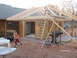 2005 Ford Mustang - A house addition is under construction, with a young boy and a dog present in the yard.