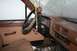 1990 Chevrolet Suburban - The interior of an older model pickup truck, likely from the 1980s, is visible with a brown dashboard and plaid seat fabric.