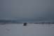 1990 Chevrolet Suburban - A yellow SUV navigates a snow-covered landscape under a cloudy sky.