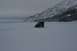 1990 Chevrolet Suburban - A black Jeep Wrangler navigates a vast, snow-covered landscape with a mountain range looming in the distance.