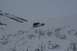 1990 Chevrolet Suburban - A white Jeep Wrangler navigates a steep, snow-covered slope in a remote, overcast landscape.
