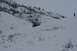 1990 Chevrolet Suburban - A dark SUV navigates a snow-covered terrain, with a lone figure observing from a distant ridge.