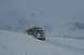 1990 Chevrolet Suburban - SUV navigating a snowy mountain pass in winter conditions.