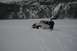 1990 Chevrolet Suburban - Jeep Wrangler stuck in deep snow with a person observing the situation.