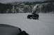 1990 Chevrolet Suburban - A Jeep Wrangler navigates a snow-covered landscape with mountains in the background.