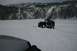 1990 Chevrolet Suburban - A dark green Jeep Wrangler navigates a snowy landscape, with another vehicle partially visible in the foreground.