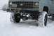 1990 Chevrolet Suburban - This pickup truck is equipped with large, snow-covered tires and a winch, ready for winter conditions.