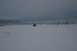 1990 Chevrolet Suburban - A lone SUV navigates a vast, snow-covered landscape under a gloomy sky.