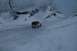 1990 Chevrolet Suburban - A white Jeep Wrangler navigates a snowy, uphill path surrounded by snow-laden trees and terrain.