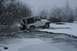 1990 Chevrolet Suburban - A white Jeep Wrangler navigates through a partially frozen body of water surrounded by snow-laden trees.