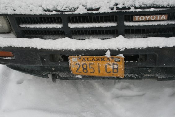 Toyota grille covered in snow with an Alaska license plate reading 2851 CB