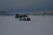 1990 Chevrolet Suburban - Two Jeep Wranglers navigate a snow-covered landscape under a cloudy sky.