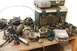 1989 Ford Bronco II - Assorted automotive parts, including carburetors and an engine control unit, are displayed on a workbench.