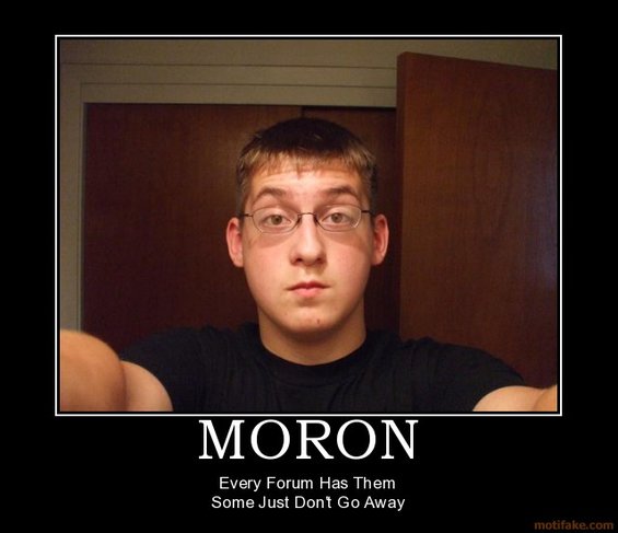 guy in a black shirt and glasses takes a selfie in front of a wooden door