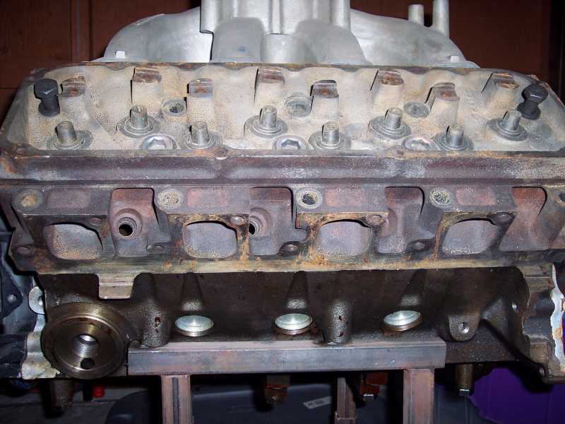 Engine block with intake manifold attached, showing exhaust ports
