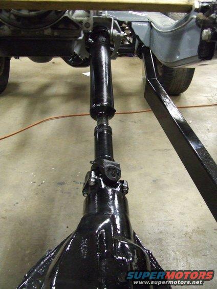 Driveshaft and differential housing, likely from a classic vehicle undergoing restoration
