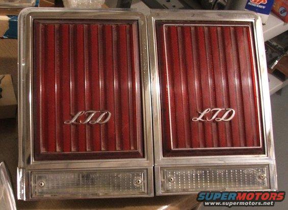 Pair of red LTD tail lights with chrome trim and clear lower sections