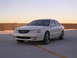 2003 Acura TL - A white 2003 Acura TL is parked on a rooftop or elevated parking structure.