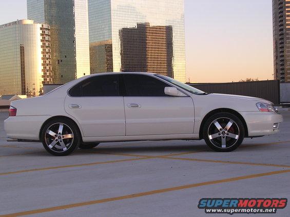 White 2003 Acura TL parked outside with buildings in the background
