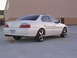 2003 Acura TL - This white 2003 Acura TL is shown from a 3/4 front angle, aftermarket wheels and a clean body style.