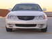 2003 Acura TL - Front view of a white 2003 Acura TL sedan with its grille and headlights visible.