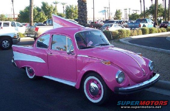 Pink Volkswagen Beetle with white fins and whitewall tires