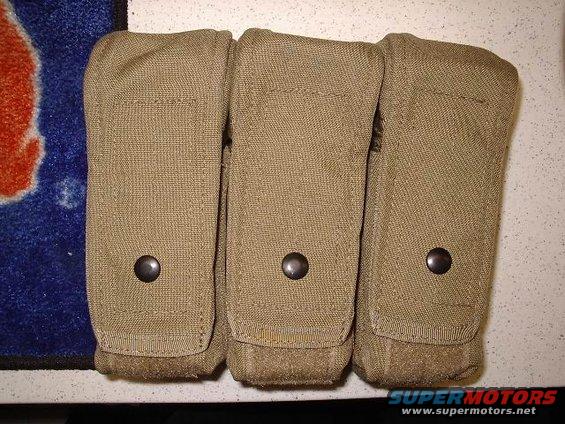 Three tan pouches with snaps on a textured surface