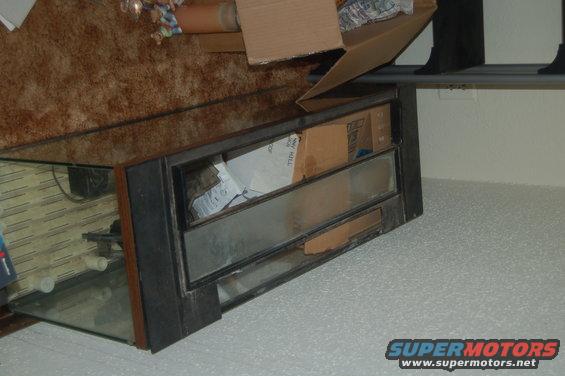 Aquarium with boxes inside, on a carpeted floor