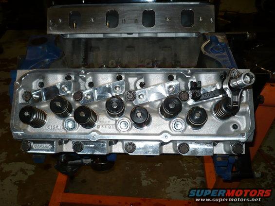 Engine cylinder head assembly showing valves, springs, and rocker arms. Part number '01G2' visible