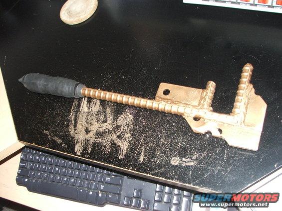 Metal part with ribbed shaft and rubber tip on a desk