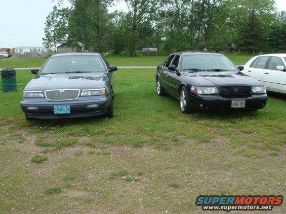Front view of a blue Mercury Grand Marquis and a black Mercury Marauder parked side-by-side