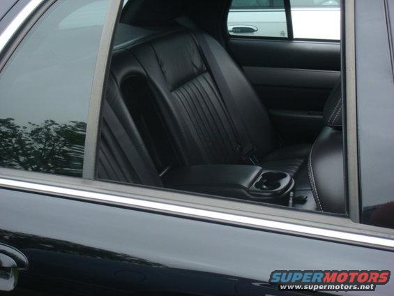 Black leather rear car seats with cup holder and seatbelt
