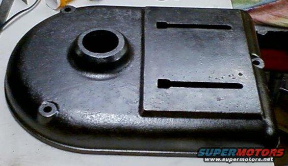 metal cover with a circular hole and two rectangular slots