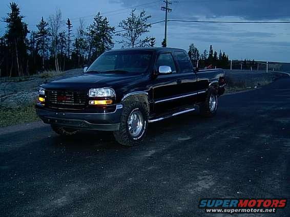 Black 1999 GMC Sierra 1500 pickup truck with chrome accents, parked on asphalt