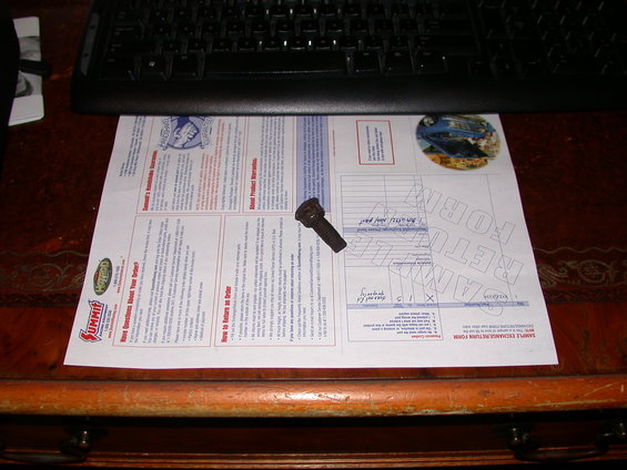 Exhaust bolt on a Summit Racing return form with a keyboard in the background