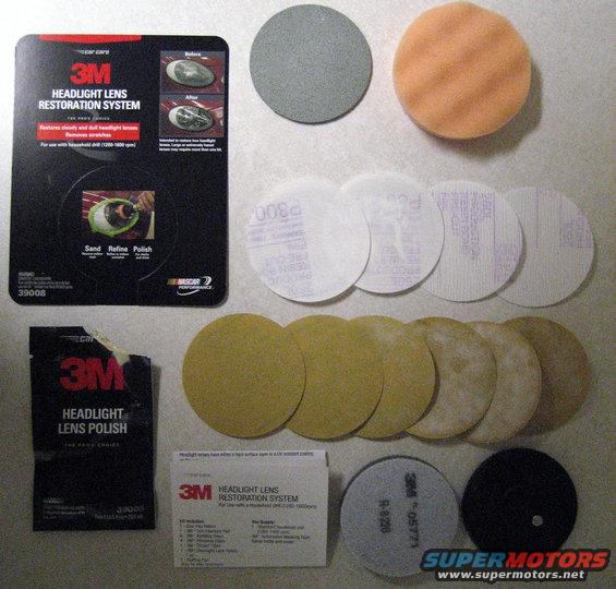 3M Headlight Lens Restoration System kit with sanding discs, polishing pads, and polish